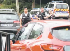  ??  ?? French police secure a street after a man killed two of his relatives and injured another person in a knife attack. — Reuters photo