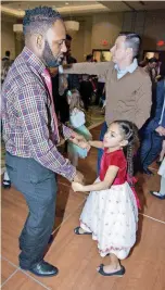  ?? [PHOTOS BY ERIECH TAPIA, FOR THE OKLAHOMAN] ?? Marcus Jones, 35, of Edmond, dances with his daughter, Kaleah Jones, 6, during the Daddy Daughter Dance at the Edmond Conference Center.