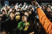  ?? RYAN DORGAN / THE NEW YORK TIMES ?? Kanye West surrounds himself with friends during the first playing of his latest album at his listening party in Moran, Wyoming, in May. West became a darling of conservati­ves after praising President Trump, among others.