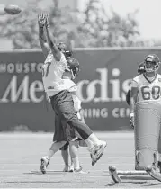  ?? Tim Warner ?? Texans rookie defensive end Daniel Ross tries to stand out during a pass rushing drill Monday.