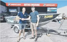  ?? Picture: GLENN HAMPSON ?? Luke Bradnam congratula­tes Ormeau’s Tony Ramsay for winning the Coast Fishing tinnie from Nitro Marine.