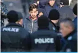  ?? ?? HARMANLI: A migrant walks among Bulgarian riot policemen inside the Harmanli Refugee center, near the Bulgarian border with Turkey on November 25, 2016. — AFP
