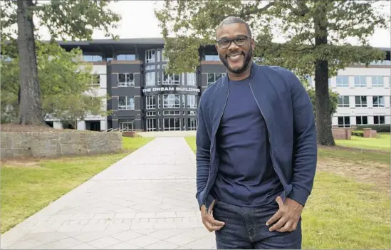  ?? Photograph­s by Tami Chappell For The Times ?? EVEN with the opening soon of “Boo! A Madea Halloween,” it’s Tyler Perry Studios that has the filmmaker, above outside “The Dream Building,” most excited.