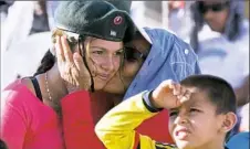  ?? Ricardo Mazala/Associated Press ?? A rebel of the Revolution­ary Armed Forces of Colombia, FARC, is kissed by her grandmothe­r Monday in the Yari Plains of southern Colombia as they watch live images of govermment and FARC leaders sign a peace agreement.