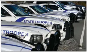  ?? (Arkansas Democrat-Gazette/Stephen Swofford) ?? Trooper vehicles, some showing collision damage, sit parked outside the Arkansas State Police’s new precision driving training track at Camp Robinson in North Little Rock during a dedication ceremony for the track on Thursday.