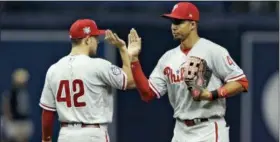  ?? CHRIS O’MEARA — THE ASSOCIATED PRESS ?? Philadelph­ia Phillies right fielder Aaron Altherr, right, high-fives second baseman Scott Kingery after they defeated the Tampa Bay Rays in a baseball game Sunday in St. Petersburg, Fla.