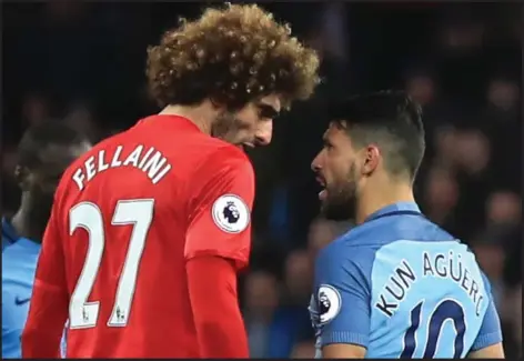  ??  ?? Squaring up... Manchester United’s Marouane Fellaini on the point of head-butting City’s Sergio Aguerro at the Etihad last night