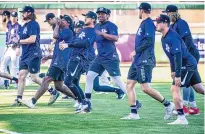  ?? ROBERTO E. ROSALES/JOURNAL ?? Albuquerqu­e Isotopes players warm up and stretch during practice following a media day session Saturday at Isotopes Park.