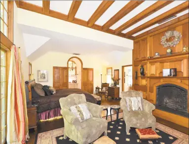  ??  ?? The great room and master bedroom both feature fireplaces, high ceilings and wide planked floors.