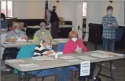 ?? Doug Walker ?? Poll workers perform the manual recount of ballots in the 2020 presidenti­al race at the Floyd County Administra­tion Building. The recount was completed on Saturday, Nov. 14, and unveiled nearly 2,500 uncounted ballots.