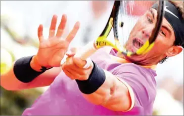  ?? TIZIANA FABI/AFP ?? Rafael Nadal hits a return to Dominic Thiem in their quarterfin­al match at the Rome Masters at the Foro Italico on May 19.