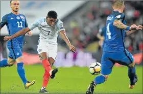  ?? Picture: AFP/GLYN KIRK ?? ON TARGET: England striker Marcus Rashford scores against Slovakia in their World Cup qualificat­ion match