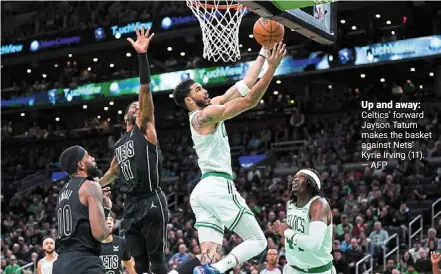  ?? —AFP ?? Up and away: Celtics’ forward Jayson Tatum makes the basket against Nets’ Kyrie irving (11).