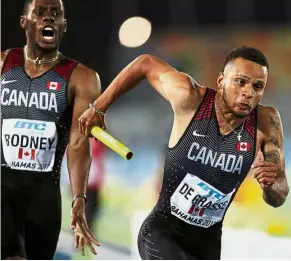  ??  ?? Getting it right this time: Canada’s Brendon Rodney (left) handing the baton to Andre De Grasse in the men’s 4x200m relay final at the IAAF World Relays in Bahamas on Sunday. — AFP