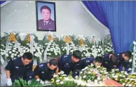  ?? GU HUAXIA / FOR CHINA DAILY ?? Fellow police officers pay their final respects to Gao Guangxi, former chief of the Chengnan police station, at his funeral in Haian, Jiangsu province, on July 4. Gao died at work on July 1.