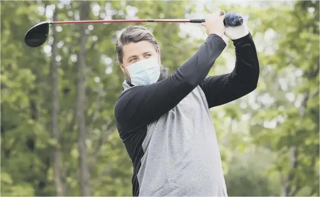 ?? PICTURE: PETER BYRNE/PA ?? 0 A golfer at Allerton Manor in Liverpool wears a face mask as an additional precaution­ary measure as courses reopened in England yesterday following a seven-week lockdown. England Golf chief executive Jeremy Tomlinson said: “Today, more than any other, it really is the taking part that counts.”