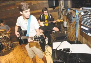  ?? Alex von Kleydorff / Hearst Connecticu­t Media ?? Wilton’s Ben Teolis works on a guitar intro to a David Bowie song during rehearsals with the Paul Green Rock Academy of Connecticu­t at the Factory Undergroun­d Studio in Norwalk on Thursday. At right, School of Rock founder Paul Green helps out with...