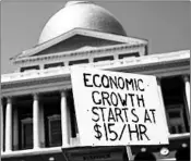  ?? CJ GUNTHER/EPA ?? The average hourly pay, adjusted for inflation, was $10.76 in July. Protesters are pushing for a minimum wage of $15.