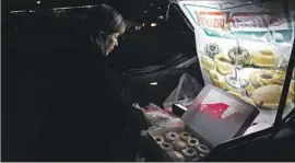  ?? Katie Falkenberg Los Angeles Times ?? SONIA GARCIA runs the “Krispy Kreme Familia” from the trunk of her car in Juarez, Mexico. She and her son sell the doughnuts nightly from two locations.