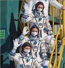  ?? AFP PIC ?? (From top) Expedition 65 cosmonaut Pyotr Dubrov, astronaut Mark Vande Hei and cosmonaut Oleg Novitskiy waving prior to boarding the Soyuz MS-18 spacecraft for launch at the Baikonur Cosmodrome in Kazakhstan yesterday.