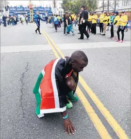  ??  ?? ELISHA BARNO of Kenya collects himself after winning the 32nd Annual Los Angeles Marathon. Barno finished in 2 hours 11 minutes 51 secons.