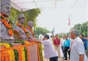  ?? — PTI ?? Chief minister Arvind Kejriwal and Delhi Assembly Speaker Ram Niwas Goel pay tribute to Shaheed Bhagat Singh on his birth anniversar­y in New Delhi.