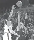  ?? PATRICK BREEN/THE REPUBLIC ?? GCU’s Roberts Blumbergs (12) shoots against New Mexico State’s Eli Chuha during the first half at GCU Arena on Saturday night.