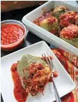  ?? Tribune News Service ?? ■ Bell peppers stuffed with a cheesy mixture of sweet Italian sausage, brown rice and Parmesan cheese make a hearty fall meal.