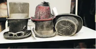  ??  ?? Dust-covered hats wait to be claimed. Burning Man organizers say they have roughly a 60 per cent success rate at returning lost items.