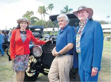  ?? TAIMY ALVAREZ/SOUTH FLORIDA SUN SENTINEL FILE ?? Jay Leno, Rita & Rick Case, founders of the Boca Raton Concours d’Elegance, pose for pictures during the kick-off news conference ahead of the Concours d’Elegance car show at the Boca Raton Resort & Club in Boca Raton in 2019.