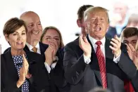  ?? Associated Press ?? ■ President Donald Trump applauds next to Governors Pete Ricketts of Nebraska, second left, and Kim Reynolds of Iowa, left, on June 11 in Council Bluffs, Iowa. An executive order by Trump giving states the right to refuse to take refugees is putting Republican governors in an uncomforta­ble position. They’re caught between immigratio­n hardliners who want to shut the door and others who believe helping refugees is a moral obligation.