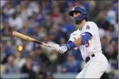  ?? JAE C. HONG — THE ASSOCIATED PRESS ?? The Los Angeles Dodgers’ Chris Taylor watches his tworun home run in the second inning against the Atlanta Braves in Game 5of the National League Championsh­ip Series on Thursday in Los Angeles.