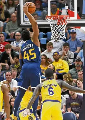  ?? —AP ?? Utah guard Donovan Mitchell pierces the LA Lakers defense for a thunderous slam.