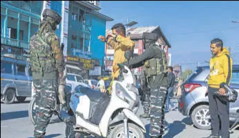  ?? AFP ?? A soldier frisks a motorist along a street in Srinagar on Friday.