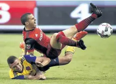  ?? NATHAN DENETTE/THE CANADIAN PRESS ?? Colorado defender Kortne Ford and Toronto FC’s Sebastian Giovinco battle for the ball last month in Toronto. It’s first against worst in the MLS on Saturday as league-leading Toronto FC travels to D.C. United on the heels of dropping two points in a...