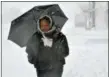  ?? FILE PHOTO ?? A pedestrian carries an umbrella to protect herself from the storm.