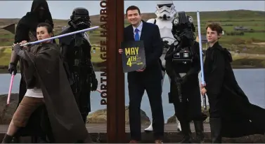  ?? Photo Valerie O’Sullivan ?? Tourism Minister Brendan Griffin with some of the Star Wars characters that took part in the May The Fourth Festival in Portmagee.