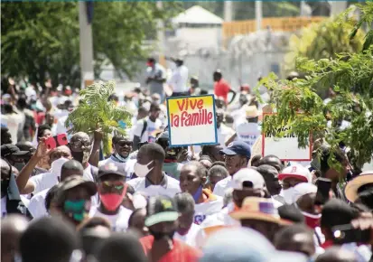  ?? ESTAILOVE ST-VAL AFP via Getty Images ?? Protesters and church members march and pray during a protest against the updated penal code — in particular, its measures outlawing discrimina­tion based on sexual orientatio­n — in Port-au-Prince on July 26.