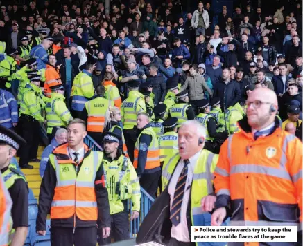  ??  ?? Police and stewards try to keep the peace as trouble flares at the game