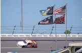  ?? PHELAN M. EBENHACK/ASSOCIATED PRESS FILE ?? During this event at Daytona Internatio­nal Speedway in 2015, the Confederat­e flag waves near Turn 4. As of Wednesday, no longer will the flag be welcome at any NASCAR property.