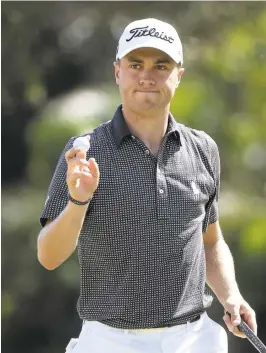  ?? SAM GREENWOOD/GETTY IMAGES ?? Justin Thomas reacts to his par putt on the first green during the final round on Sunday.