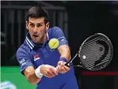  ?? Adam Pretty / Getty Images ?? Novak Djokovic hits a backhand to Austria’s Dennis Novak during a group F match Friday at Innsbruck.