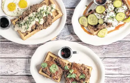  ?? Provided ?? Tupelo Honey has three versions of chicken and waffles: Country Style, from left, Sriracha Honey and Mac-n-Cheese with Asheville Hot Fried Chicken.