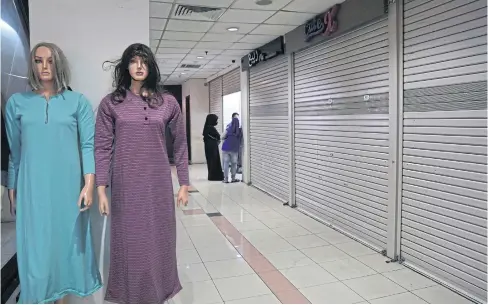  ?? BLOOMBERG ?? Mannequins stand near a closed shop at Tanah Abang market in Jakarta on Tuesday.