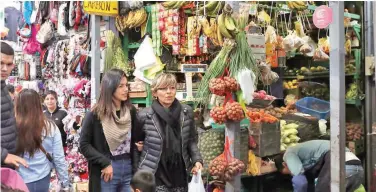  ?? R euters ?? ±
People walk at Surco market in Lima, Peru.