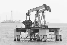  ??  ?? An oil rig sits at sea near Maracaibo, 500km, from Caracas. Venezuelas oil industry suffers from the country’s political unrest and sinking economy. Venezuela might look bad right now with protests, scarce food and fraught political tensions. But it...