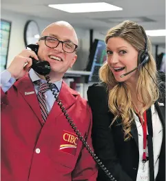  ??  ?? Legends of Tomorrow’s Jes Macallan on the phone with a client, joined by a CIBC trader. CIBC Miracle Day is one of Canada’s largest single-day corporate fundraisin­g events in support of children’s charities. Supplied
