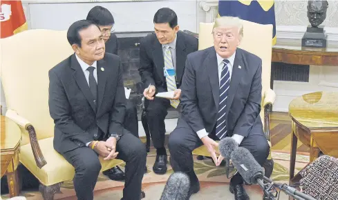  ?? BLOOMBERG ?? US President Donald Trump speaks as Prime Minister Prayut Chan-o-cha listens during a meeting in the Oval Office of the White House in Washington DC last year.