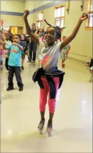  ?? MICHILEA PATTERSON — DIGITAL FIRST MEDIA ?? Franklin Elementary student Trinity Hall, 7, jumps while dancing to music during a school assembly. The school won a Wellness Checklist Achievemen­t Award for implementi­ng healthy programs.