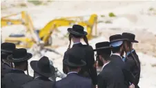  ?? (Ronen Zvulun/Reuters) ?? ULTRA-ORTHODOX PROTESTERS demonstrat­e at a constructi­on site in Beit Shemesh in 2013.